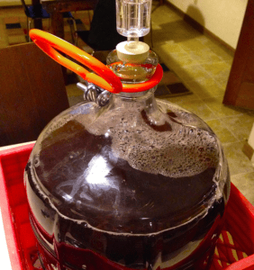 wine fermenting in glass carboy
