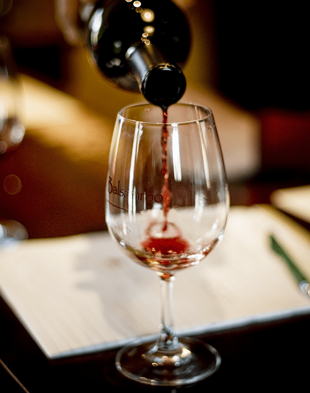 Wine Pouring Into Glass With Notes