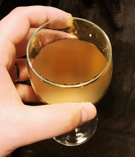 Holding A Glass Of Cloudy Mead
