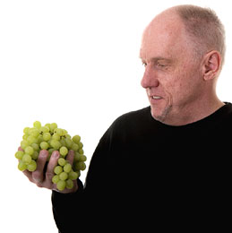 Man Holding Eating Grapes For Making Wine
