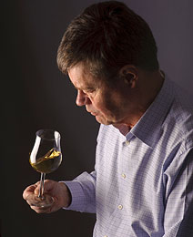man_looking_at_glass_of_wine