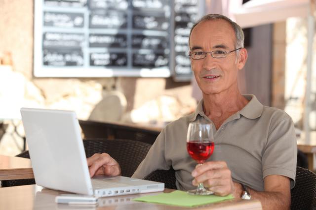 Man with Wine at Computer
