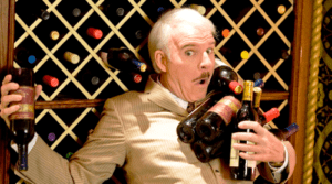 Steve Martin holding wine bottles