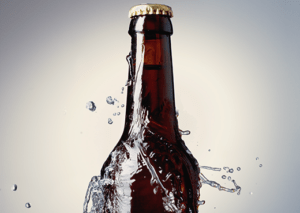 water splashed on bottle of beer